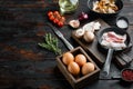 Breakfast egg ingredients  on old dark wooden table background   with space for text copyspace Royalty Free Stock Photo