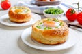 Breakfast eggs. Eggs baked in a bun with ham, cheese and herbs