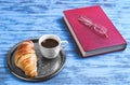 breakfast fine white porcelain cup with black coffee and a croissant Royalty Free Stock Photo