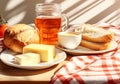 Breakfast with flakes, milk, coffee, toast, cheese and butter on a table with tablecloth with red and white squares