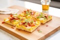 breakfast focaccia topped with eggs and bacon pieces Royalty Free Stock Photo