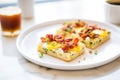 breakfast focaccia topped with eggs and bacon pieces Royalty Free Stock Photo