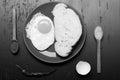 Breakfast and food art concept. Food placed on red plate on black background, top view.