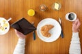 Breakfast food and man holding tablet and coffee