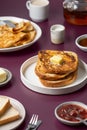 Breakfast food - plates with French toast with butter, crepes, toast bread, jam, honey, tea kettle, coffee cup, milk jug Royalty Free Stock Photo