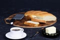 Breakfast with fresh homemade bread and hot coffee. A cup of coffee on black background Royalty Free Stock Photo