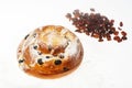 Breakfast. Fresh sweet bun with powdered sugar and raisins on white background Royalty Free Stock Photo