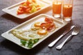 Breakfast from fried egg, bacon, vegetable salad and carrot juice. On a dark stone background Royalty Free Stock Photo