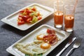 Breakfast from fried egg, bacon, vegetable salad and carrot juice. On a dark stone background Royalty Free Stock Photo