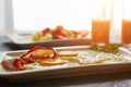 Breakfast from fried egg, bacon, vegetable salad and carrot juice. On a dark stone background Royalty Free Stock Photo