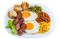 Breakfast fried egg peas, corn grains, beans and fried sausages on a white plate Royalty Free Stock Photo