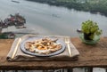 Breakfast with Fried egg, Roasted pork sprinkle garlic, chili in plate with Knife and fork on old wooden table Royalty Free Stock Photo