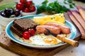 Breakfast with fried egg, sausages, bread, tomato, cheese Royalty Free Stock Photo