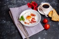 Breakfast. Fried eggs with bacon decorated with basil leaves. Royalty Free Stock Photo