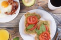 Breakfast with fried eggs with bacon and sandwiches with guacamole sauce, juse and coffee Royalty Free Stock Photo