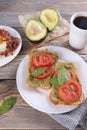 Breakfast with fried eggs and bacon and sandwiches with guacamole sauce and coffee Royalty Free Stock Photo