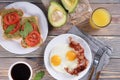 Breakfast with fried eggs and bacon and sandwiches with guacamole sauce Royalty Free Stock Photo