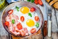 Breakfast with fried eggs, bacon, tomatoes and parsley Royalty Free Stock Photo