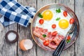 Breakfast with fried eggs, bacon, tomatoes and parsley Royalty Free Stock Photo