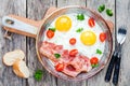 Breakfast with fried eggs, bacon, tomatoes and parsley Royalty Free Stock Photo