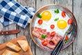 Breakfast with fried eggs, bacon, tomatoes and parsley Royalty Free Stock Photo