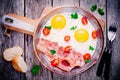 Breakfast with fried eggs, bacon, tomatoes and parsley Royalty Free Stock Photo