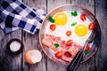 Breakfast with fried eggs, bacon, tomatoes and parsley Royalty Free Stock Photo