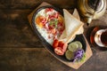 Breakfast with fried eggs in cast iron frying pan  with bread and vegetables on old dark wooden table background,spot focus,top Royalty Free Stock Photo