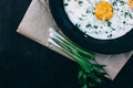 Breakfast. Fried eggs in cast iron frying pan on dark wooden background Royalty Free Stock Photo