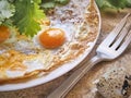 Breakfast. fried eggs with greens on a white plate. next to the eggshell Royalty Free Stock Photo
