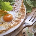 Breakfast. fried eggs with greens on a white plate. next to the eggshell Royalty Free Stock Photo
