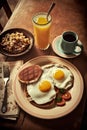 Breakfast with fried eggs, pancakes and orange juice on wooden table Royalty Free Stock Photo