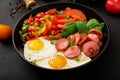 Breakfast. Fried eggs with sausage and vegetables Royalty Free Stock Photo