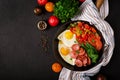 Breakfast. Fried eggs with sausage and vegetables in a frying pan Royalty Free Stock Photo