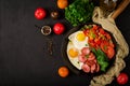 Breakfast. Fried eggs with sausage and vegetables in a frying pan Royalty Free Stock Photo