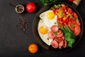 Breakfast. Fried eggs with sausage and vegetables in a frying pan Royalty Free Stock Photo