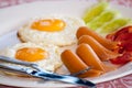 Breakfast with fried eggs, sausages, cereal, toasts and coffee