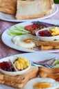 Breakfast with fried eggs, sausages, cereal, toasts and coffee