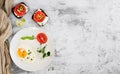 Breakfast with fried eggs, toasts with cheese, tomatoes and spices. Top view, space for text, breakfast concept