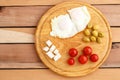Breakfast. Fried eggs, tomatoes, olives and cheese on a wooden plate. Top view Royalty Free Stock Photo