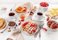 Breakfast with granola berry nuts, waffle, toast, jam, chocolate spread and coffee Royalty Free Stock Photo