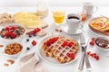 Breakfast with granola berry nuts, waffle, toast, jam, chocolate spread and coffee Royalty Free Stock Photo