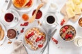 Breakfast with granola berry nuts, waffle, toast, jam, chocolate spread and coffee. Top view Royalty Free Stock Photo