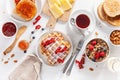 Breakfast with granola berry nuts, waffle, toast, jam, chocolate spread and coffee. Top view Royalty Free Stock Photo