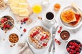 Breakfast with granola berry nuts, waffle, toast, jam, chocolate spread and coffee. Top view Royalty Free Stock Photo