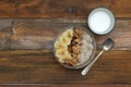 Breakfast with Granola Bowl, Muesli with Oats, Nuts and Dried Fruit, Milk, on Wooden table. Bannana, nuts, fruits. Healthy Breakfa