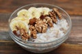 Breakfast with Granola Bowl, Muesli with Oats, Nuts and Dried Fruit, Milk, on Wooden table. Bannana, nuts, fruits. Healthy Breakfa