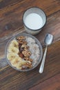 Breakfast with Granola Bowl, Muesli with Oats, Nuts and Dried Fruit, Milk, on Wooden table. Bannana, nuts, fruits. Healthy Breakfa