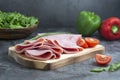 Breakfast with ham slices isolated on cutting board with fresh vegetables over dark background Royalty Free Stock Photo
