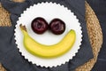BREAKFAST WITH A HAPPY FACE MADE WITH FRUIT, ONE BANANA AND TWO Royalty Free Stock Photo